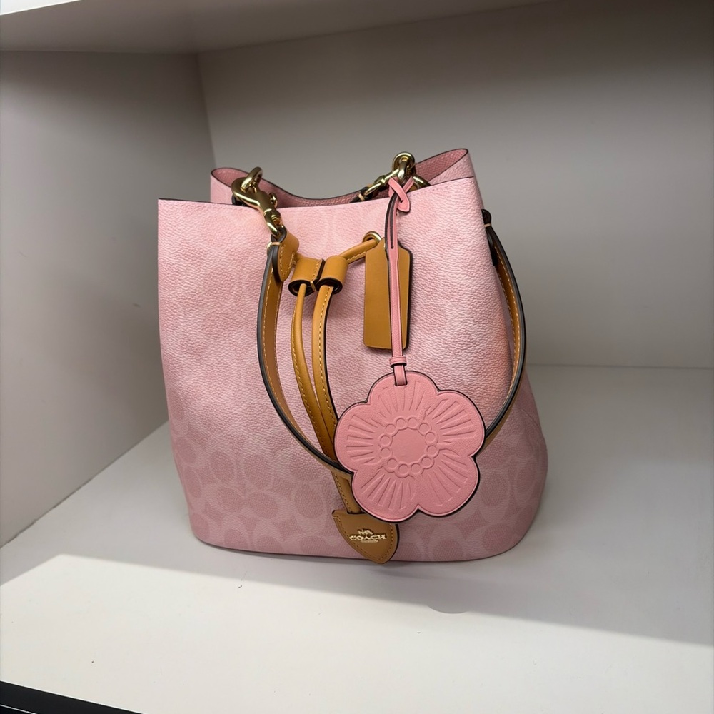 Coach Pink Leather Drawstring Bucket Bag with Tan Accents and Floral Charm